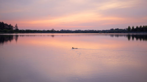 Scenic view of lake against sky during sunset