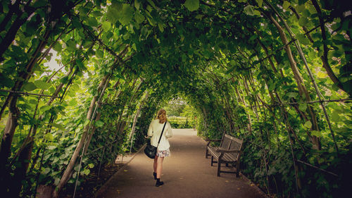 Woman standing by plants