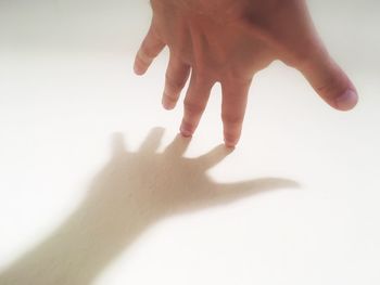 Close-up of hands over white background