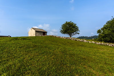 Stone shelter among the green meadows on the mountains above revine lago treviso veneto italy