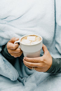 Unrecognizable woman holding a cup of hot chocolate with marshmallows