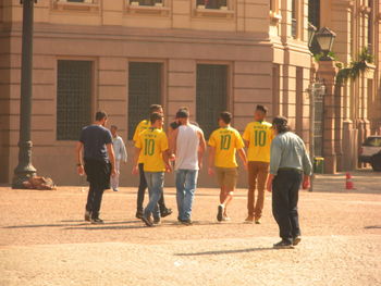 People standing on street against buildings in city