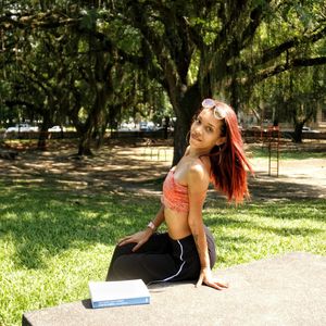 Young woman sitting in park