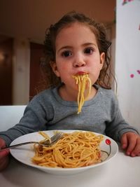 Portrait of cute girl eating food