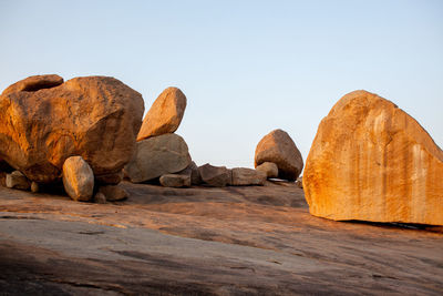 Rocks on desert against clear sky