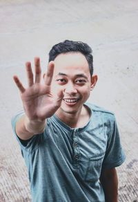 Portrait of a smiling young man standing outdoors