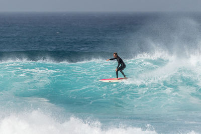 Full length of man surfing in sea