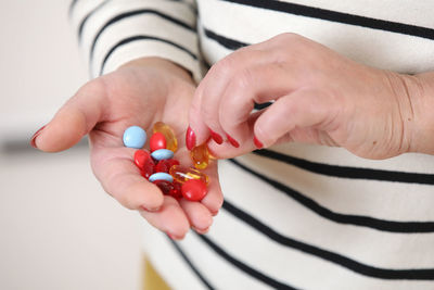 Cropped hand of woman holding pills