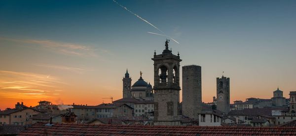 View of buildings in city at sunset