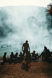 Crowd on beach against sky