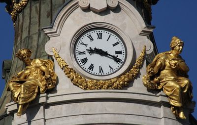 Clock on top of a building on a main street in madrid