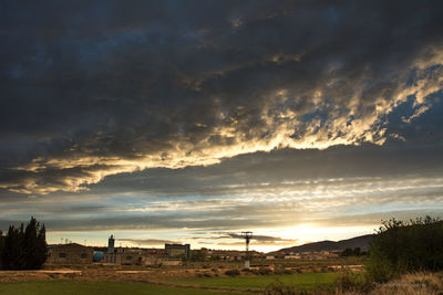 Scenic view of townscape against sky during sunset