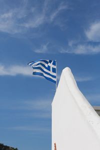 Low angle view of flag against blue sky