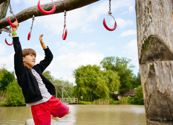 Climbing boy on the playground outside in center parc in niederlande