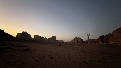 Scenic view of desert against sky during sunset