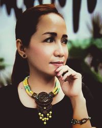 Close-up portrait of a young woman looking away