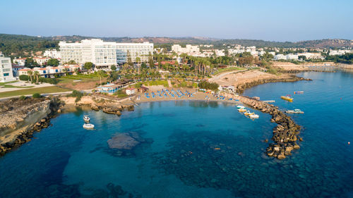 High angle view of sea and buildings against sky