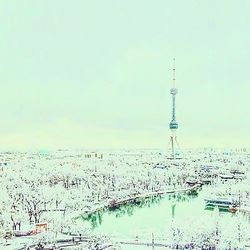 Aerial view of communications tower against sky in city