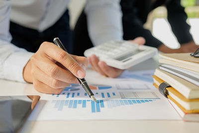 Close-up of man working on paper
