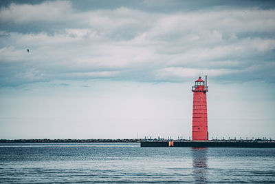 Red lighthouse over lake michigan