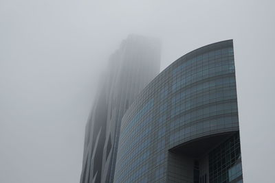 Low angle view of modern buildings against sky in city