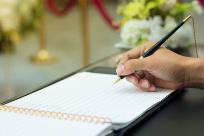Close-up of hand holding book