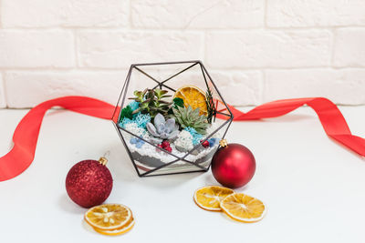 Close-up of fruits on table against wall