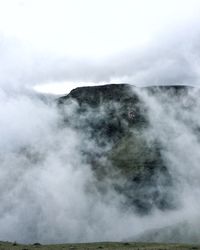 Scenic view of mountains against cloudy sky