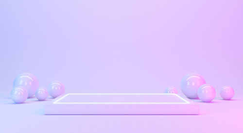 Close-up of multi colored balls on table against gray background