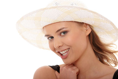 Portrait of smiling young woman against white background