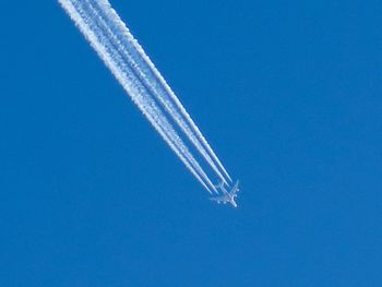 Airplane flying against clear blue sky