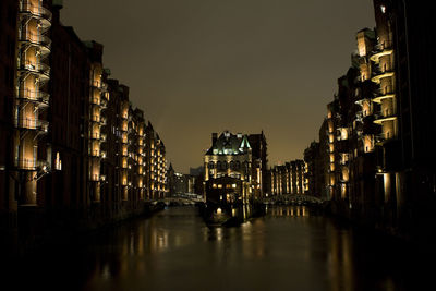 Illuminated buildings in city at night