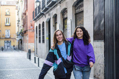 Young friends walking outdoors on the street.