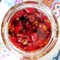 High angle view of strawberries in glass jar on table