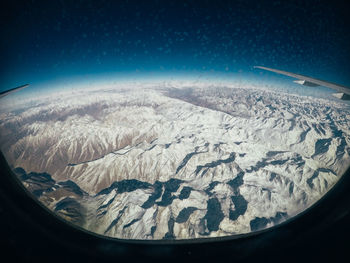 Aerial view of snowcapped mountains against sky