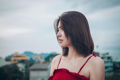 Portrait of beautiful woman against sky