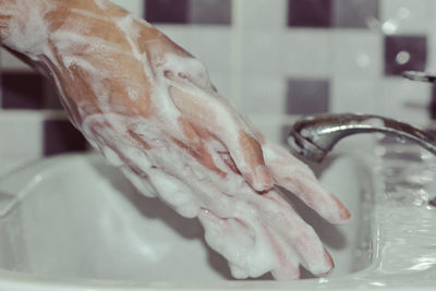 Close-up of human hand in bathroom