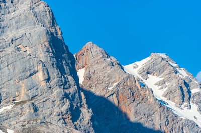 Scenic view of snowcapped mountains against clear blue sky