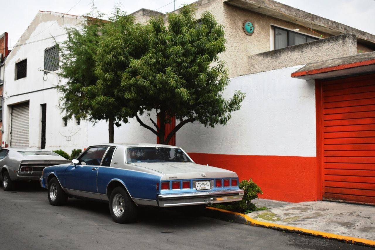 CAR ON HOUSE AGAINST SKY