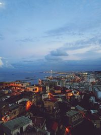 High angle shot of illuminated cityscape against sky