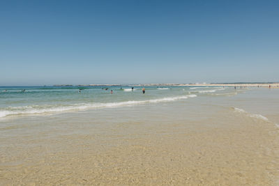 Scenic view of beach against clear sky