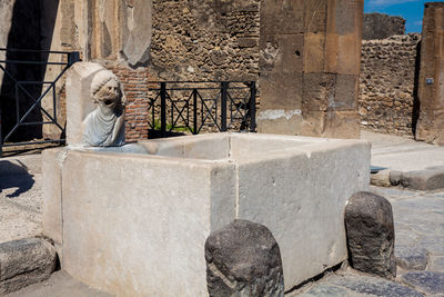 Antique water fountain on the streets of the ancient city of pompeii