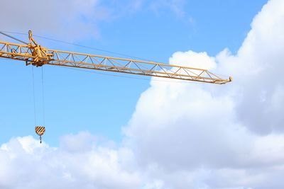 Low angle view of crane against sky