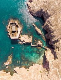 High angle view of rock formation by sea