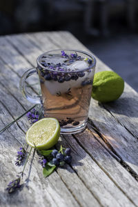 Cold refreshing tea with blueberry, lime and lavender on a hot summer day