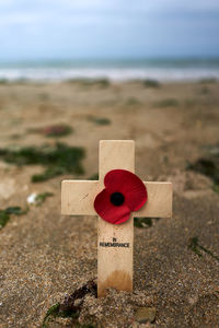 Close-up of cross on beach against sky to remember the victims of war at utah beach normandy france