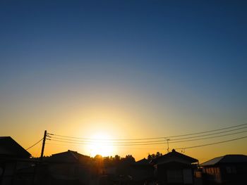 Low angle view of silhouette buildings against sky during sunset