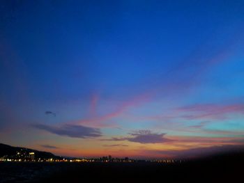 View of illuminated city at sunset
