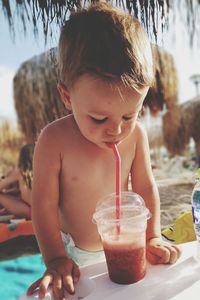 Close-up of boy drinking drink