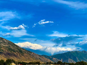 Scenic view of mountains against blue sky